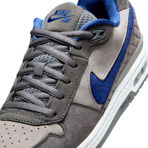 Gray and blue sneaker with Nike logo on a white background