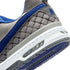 Close-up of a gray and blue sneaker with 'H' logo on a white background