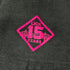 close up of pink 'Lick 15 Years' logo on sleeve of black shirt