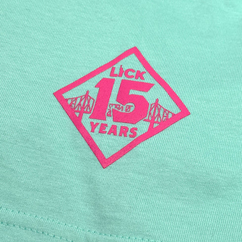 mint green shirt with pink 'Lick 15 Years' logo