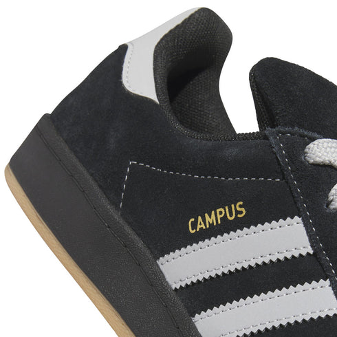 Black Adidas Campus sneaker with grey stripes and yellow text on a white background